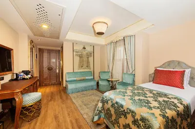 a hotel room with a bed and a desk and chairs at Romance Istanbul Hotel Boutique Class in Istanbul
