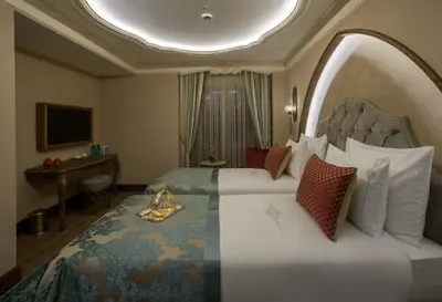 a hotel room with a large bed and a television at Romance Istanbul Hotel Boutique Class in Istanbul