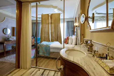 a bathroom with a bed and a sink and a mirror at Romance Istanbul Hotel Boutique Class in Istanbul