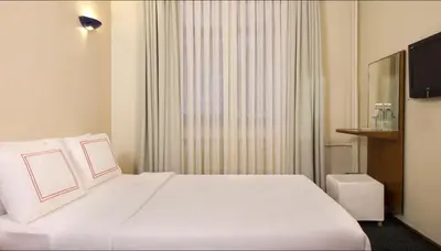 a hotel room with a white bed and a window at Ilkay Hotel in Istanbul