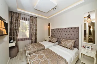 a hotel room with two beds and a window at Zeynep Sultan Hotel in Istanbul