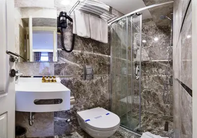 a bathroom with a toilet and a sink and a shower at Zeynep Sultan Hotel in Istanbul