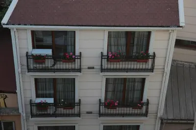 a white house with balconies with flowers on it at Art Nouveau Galata in Istanbul