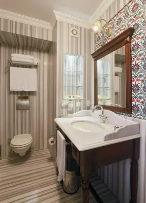 a bathroom with a sink and a toilet and a mirror at Dersaadet Hotel Istanbul in Istanbul