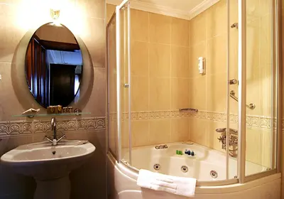 a bathroom with a shower and a sink and a tub at Dersaadet Hotel Istanbul in Istanbul
