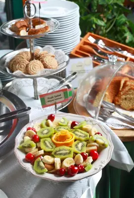 a plate of fruit and vegetables on a table at Dersaadet Hotel Istanbul in Istanbul