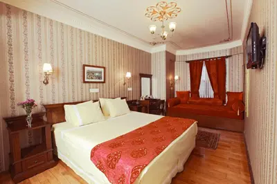 a hotel room with a bed and a chair at Dersaadet Hotel Istanbul in Istanbul