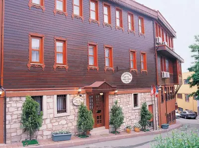 a large wooden building on the corner of a street at Hotel Tashkonak Istanbul in Istanbul