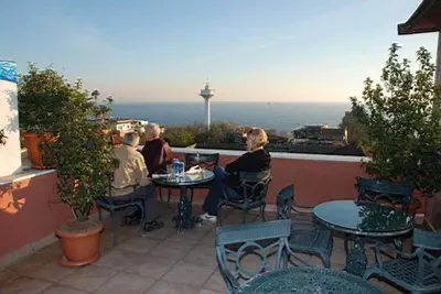 a group of people sitting at a table on a patio at Hotel Tashkonak Istanbul in Istanbul