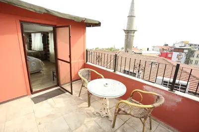 a patio with a table and chairs on a balcony at Hotel Tashkonak Istanbul in Istanbul