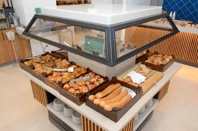 a display case with different types of bread and pastries at Holiday Inn Istanbul City by IHG in Istanbul