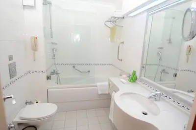 a bathroom with a sink and a tub and a toilet at Holiday Inn Istanbul City by IHG in Istanbul