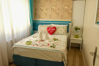 a bedroom with a bed with a red heart on it at Star Holiday Hotel in Istanbul