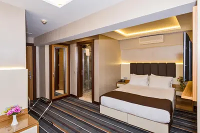 a hotel room with a bed and a balcony at Bergama Hotel Old City in Istanbul