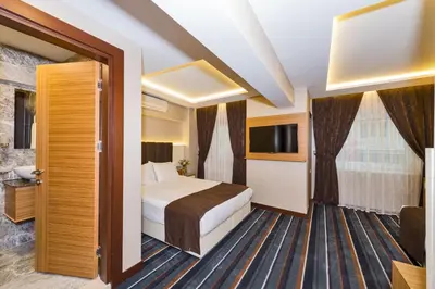 a hotel room with a bed and a window at Bergama Hotel Old City in Istanbul