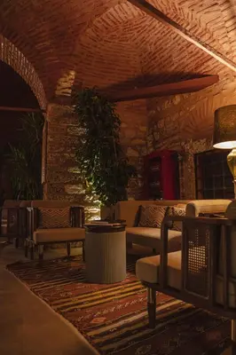 a living room with couches and a table and chairs at Han 1772 Hotel in Istanbul