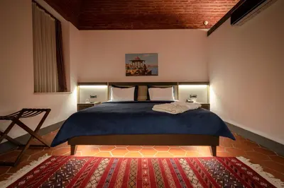 a bedroom with a bed and a red rug at Han 1772 Hotel in Istanbul