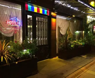 a hotel with a neon sign on the front door at Hotel Nezih Istanbul in Istanbul