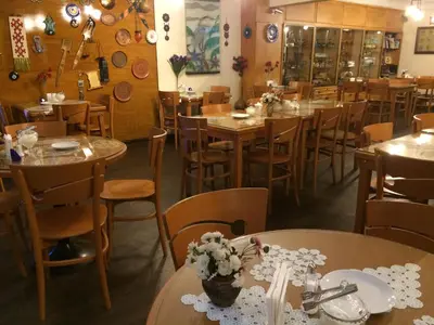 a restaurant with wooden tables and chairs and flowers on tables at Hotel Nezih Istanbul in Istanbul