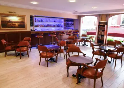 a restaurant with tables and chairs and a bar at Topkapi Inter Istanbul Hotel in Istanbul