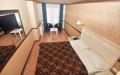 a hotel room with a bed and a flat screen tv at Topkapi Inter Istanbul Hotel in Istanbul