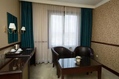a hotel room with a desk and a window at Topkapi Inter Istanbul Hotel in Istanbul