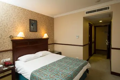 a hotel room with a bed and a door at Topkapi Inter Istanbul Hotel in Istanbul