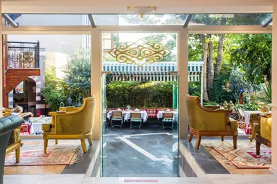 two views of a patio with chairs and tables at Garden House Hotel - Special Class in Istanbul
