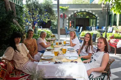 a group of women sitting around a table at Garden House Hotel - Special Class in Istanbul