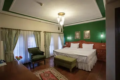 a green bedroom with a bed and a chair at Garden House Hotel - Special Class in Istanbul