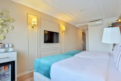 a bedroom with a white bed and a fireplace at Orient Express & Spa by Orka Hotels in Istanbul