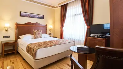 a hotel room with a bed and a television at Best Western Empire Palace Hotel & Spa in Istanbul