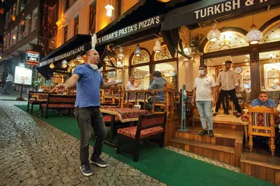 a man playing a video game in front of a restaurant at Best Western Empire Palace Hotel & Spa in Istanbul