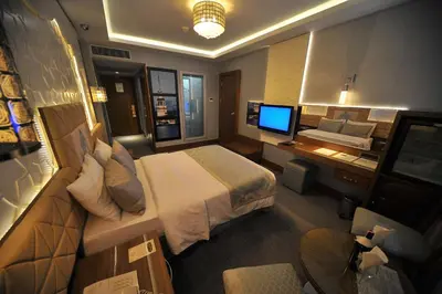 a hotel room with a bed and a desk with a computer at Grand Star Hotel Bosphorus & Spa in Istanbul