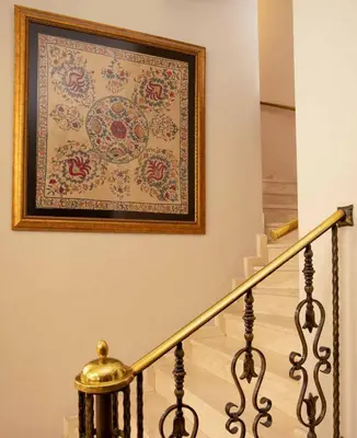 a picture hanging on a wall next to a stairway at Hotel Sultanhan - Special Category in Istanbul