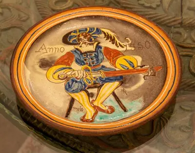 a painting of a man holding a gun on a bowl at Hotel Sultanhan - Special Category in Istanbul