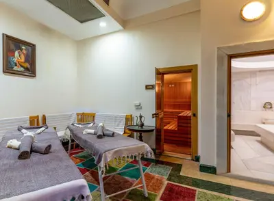 a room with two beds and a bathroom with a tub at Hotel Sultanhan - Special Category in Istanbul