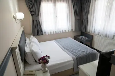 a hotel room with a bed with flowers on it at Hotel Agan Oldcity Istanbul in Istanbul