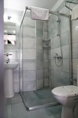 a bathroom with a shower and a toilet and a sink at Hotel Agan Oldcity Istanbul in Istanbul