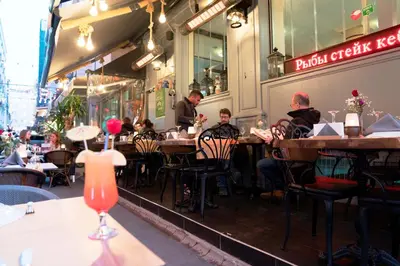 a group of people sitting at tables in a restaurant at Hotel Agan Oldcity Istanbul in Istanbul