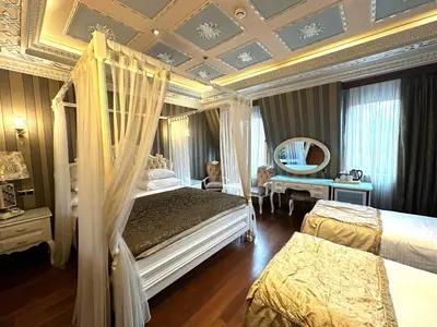 a hotel room with two beds and a mirror at Golden Horn Hotel in Istanbul