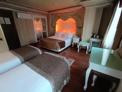 a hotel room with two beds and a piano at Golden Horn Hotel in Istanbul