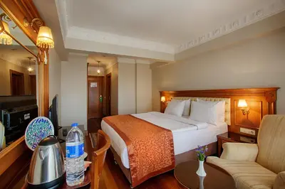 a hotel room with a bed and a couch at Hotel Sumengen in Istanbul