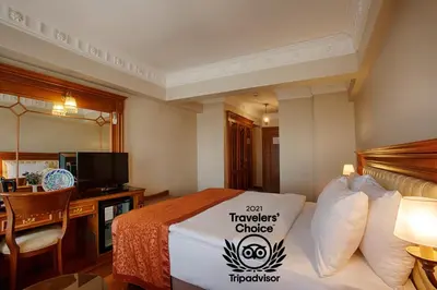 a hotel room with a bed with a sign on it at Hotel Sumengen in Istanbul