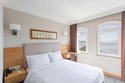 a hotel room with a bed and a window at Radisson Hotel Istanbul Sultanahmet in Istanbul