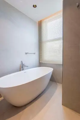 a white bath tub in a bathroom with a window at Radisson Hotel Istanbul Sultanahmet in Istanbul