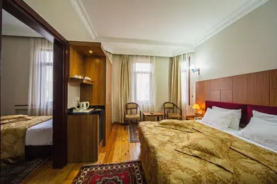 a hotel room with a large bed and a room with at Hippodrome Hotel in Istanbul