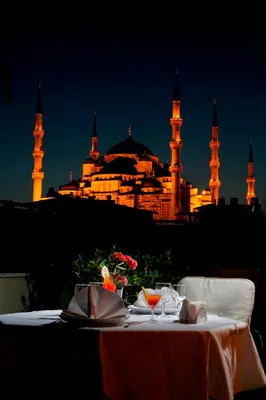 a table in front of a mosque at night at Hippodrome Hotel in Istanbul