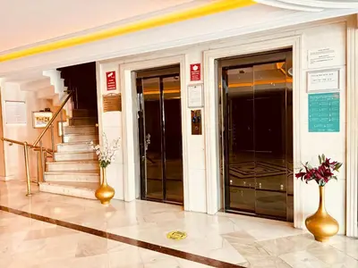 a lobby with two elevators and stairs in a building at Askoc Hotel & SPA in Istanbul