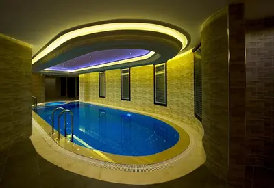 a large swimming pool in a building with a ceiling at Askoc Hotel & SPA in Istanbul